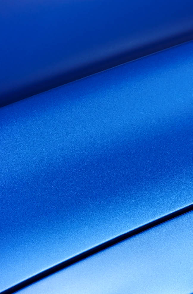 Surface of blue sport sedan car metal hood; part of vehicle bodywork 